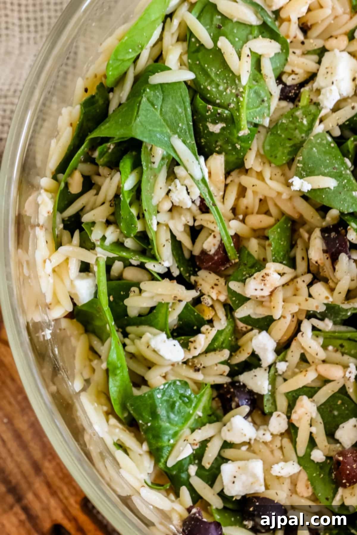 Greek Spinach Feta Orzo Salad 7 A bowl of spinach and feta salad with orzo.