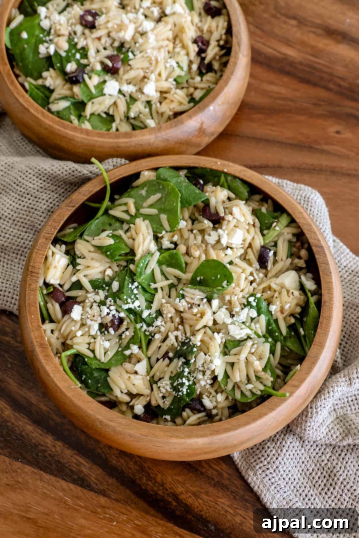 Greek Spinach Feta Orzo Salad 8 Two wooden bowls of feta and orzo salad.
