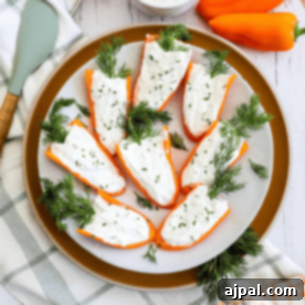 Stuffed peppers with goat cheese and dill on a plate.