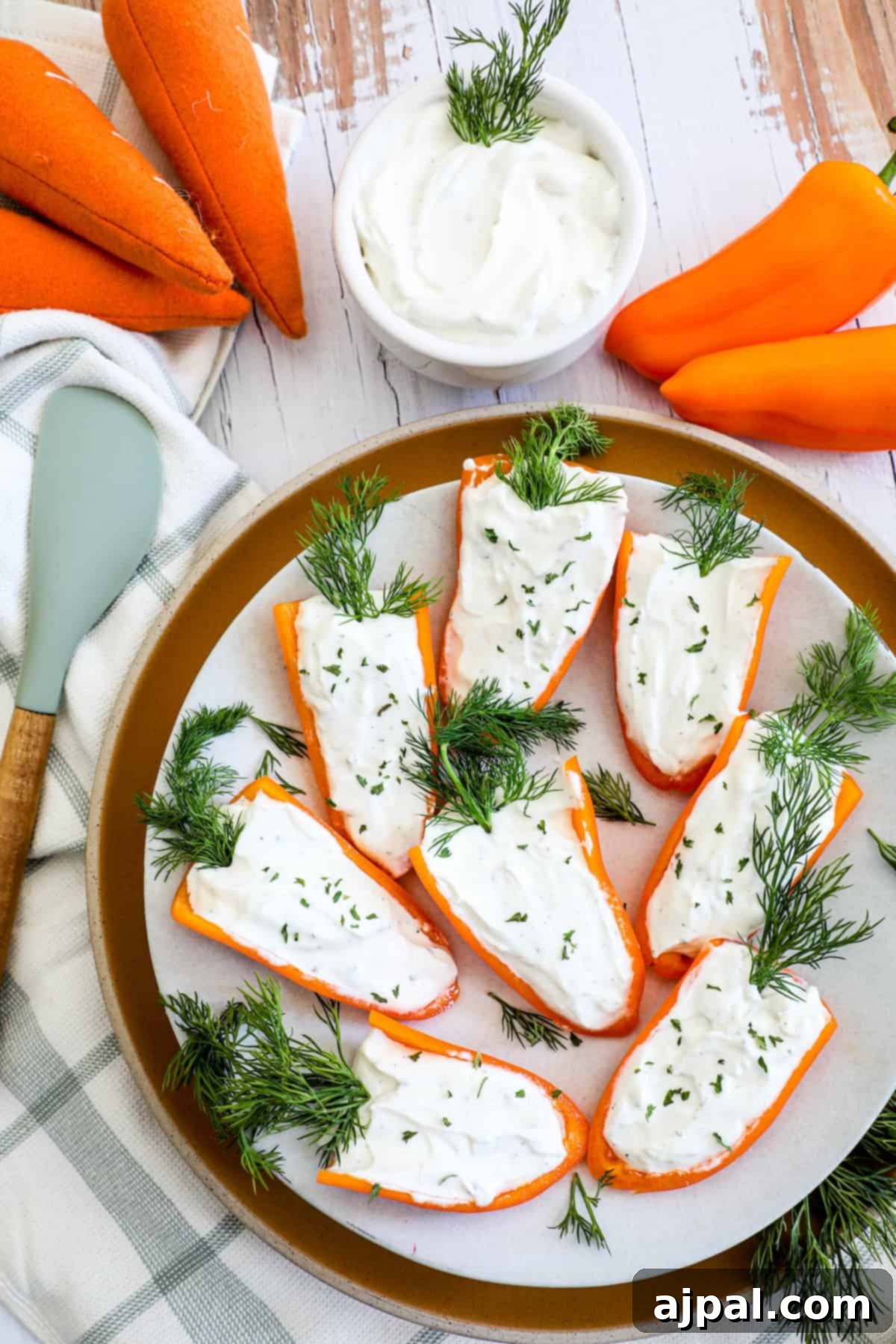 A plate with carrots, pepper, and dill on it.