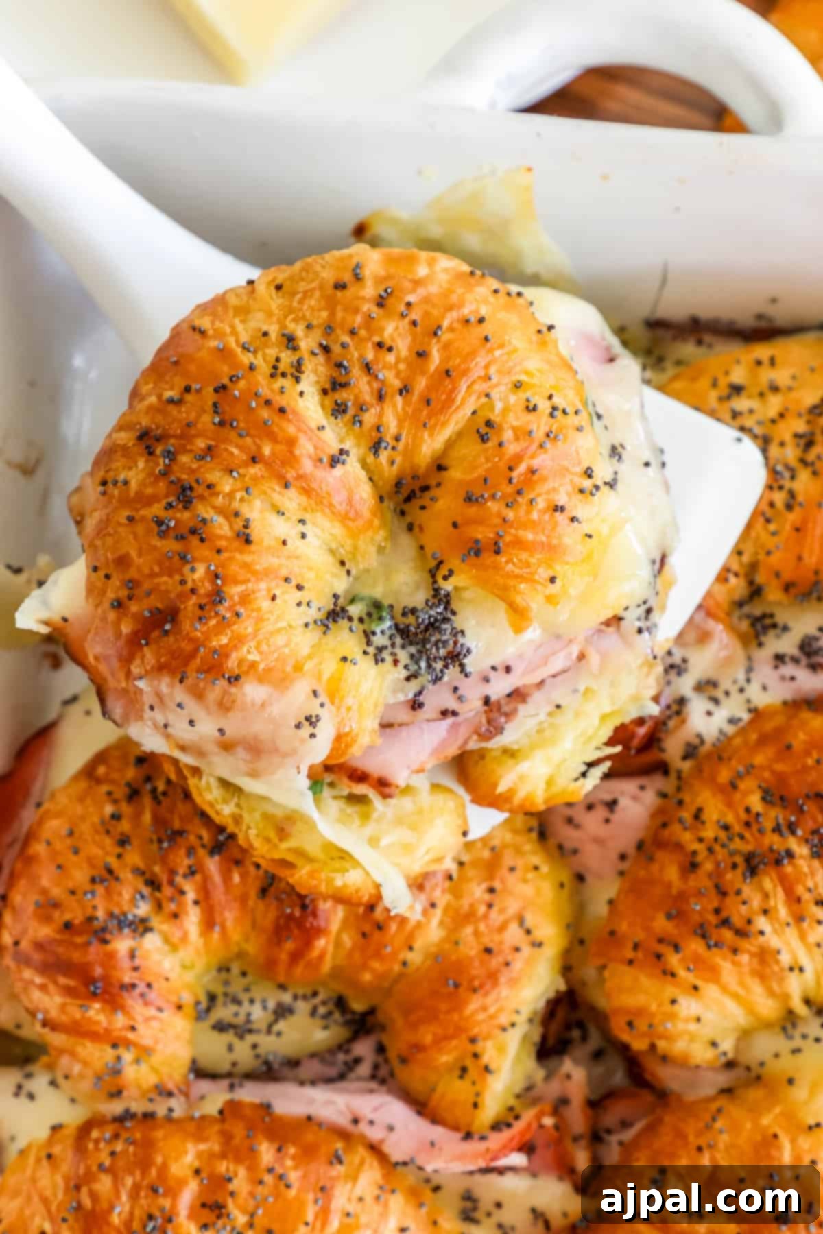 Warm Ham and Cheese Croissant Melts 15 Ham and cheese croissants baking in a dish, showing the golden-brown crust.
