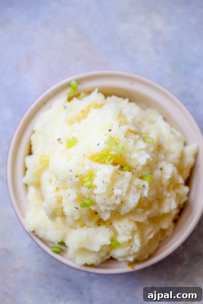 Creamy Slow Cooker Mashed Potatoes 4 Easy mashed potatoes recipe served in a bowl on a table.