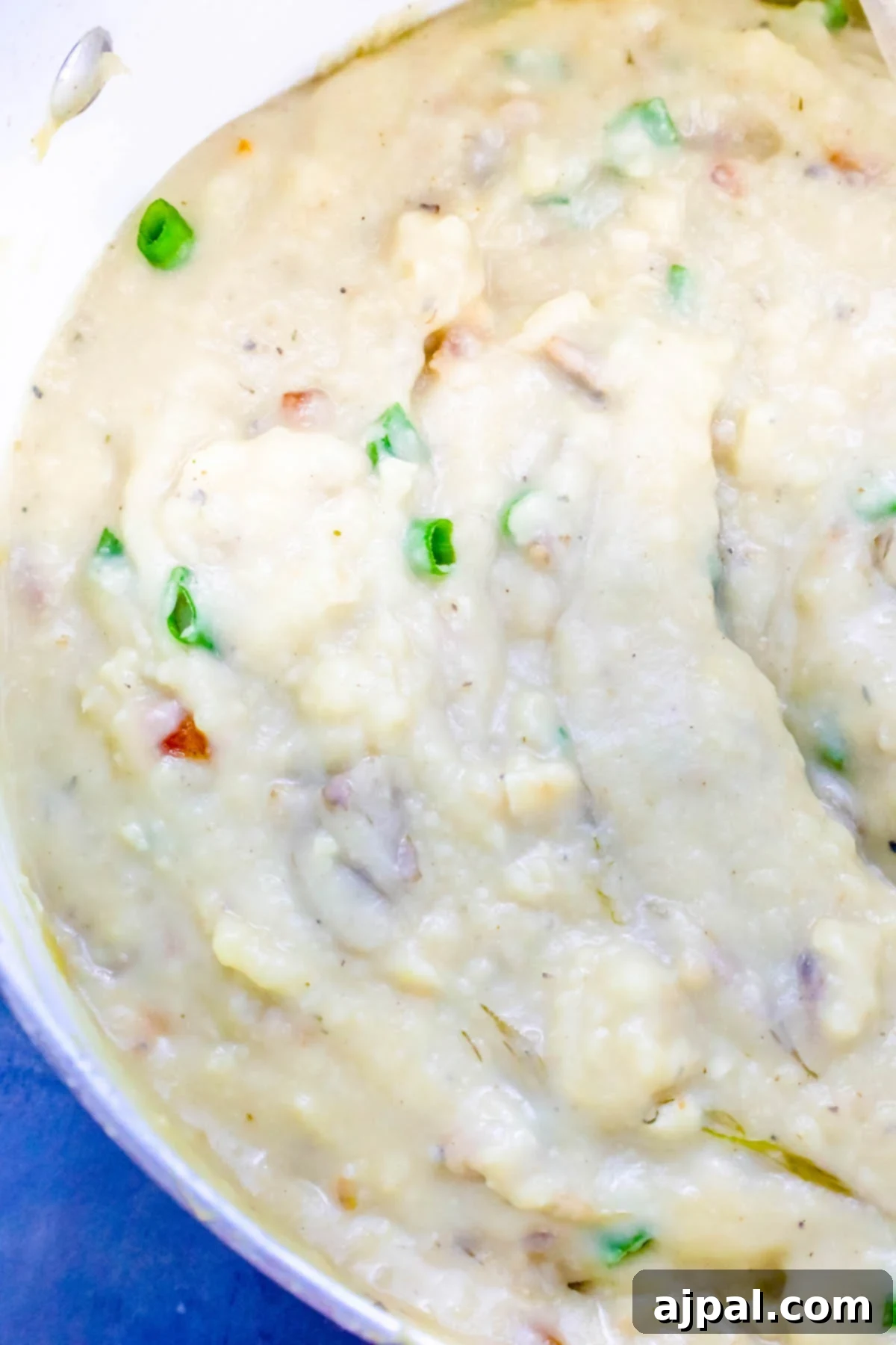 Simple Loaded Mashed Potato Revival Soup 2 creamy potato soup with green onions, ready to be served