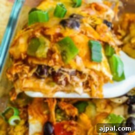 A serving of layered chicken taco casserole with fresh green bell peppers on top.