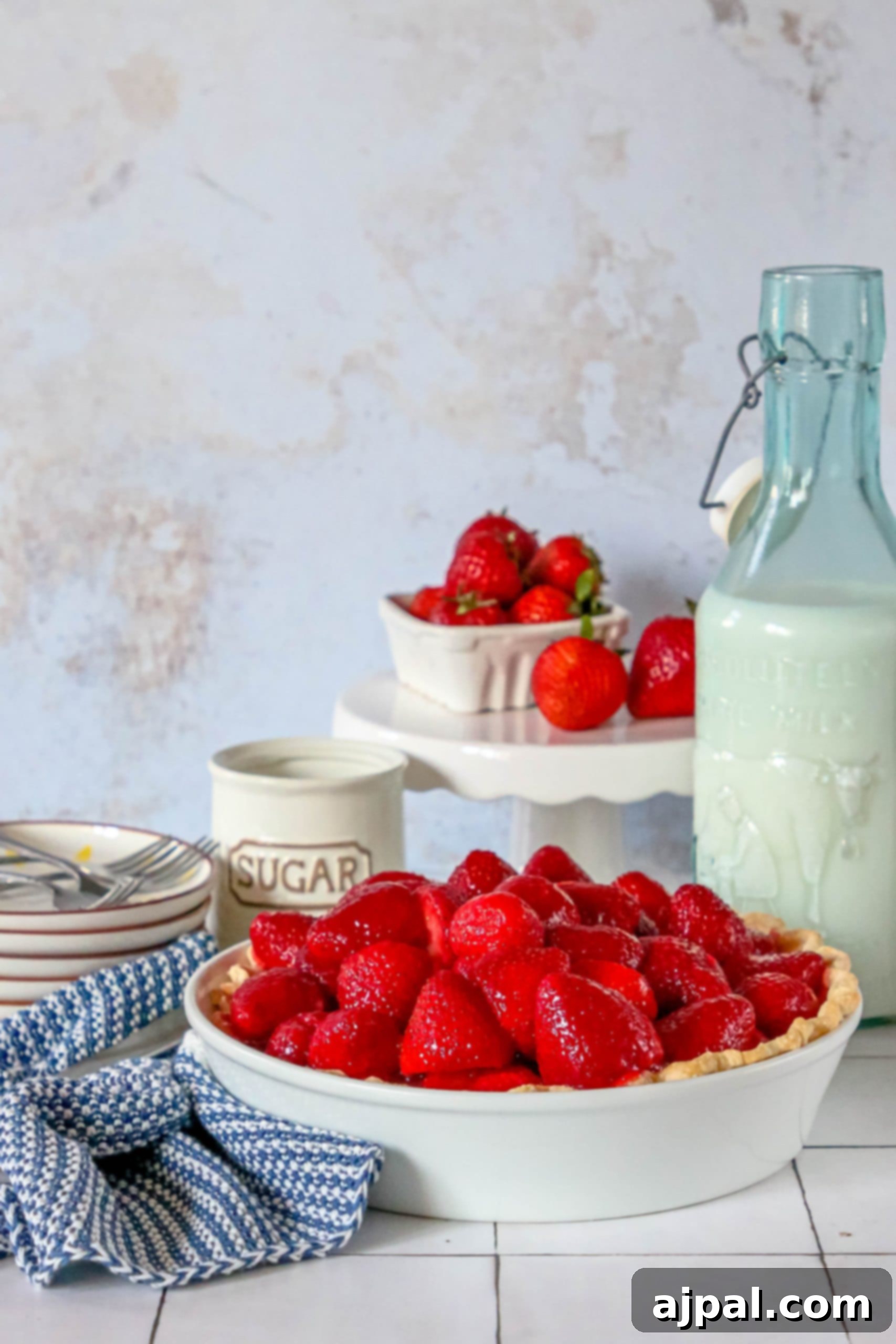 Sweet Summer Strawberry Pie 5 An easy strawberry pie proudly sits beside a classic bottle of milk on a rustic wooden table, embodying simple summer pleasures.