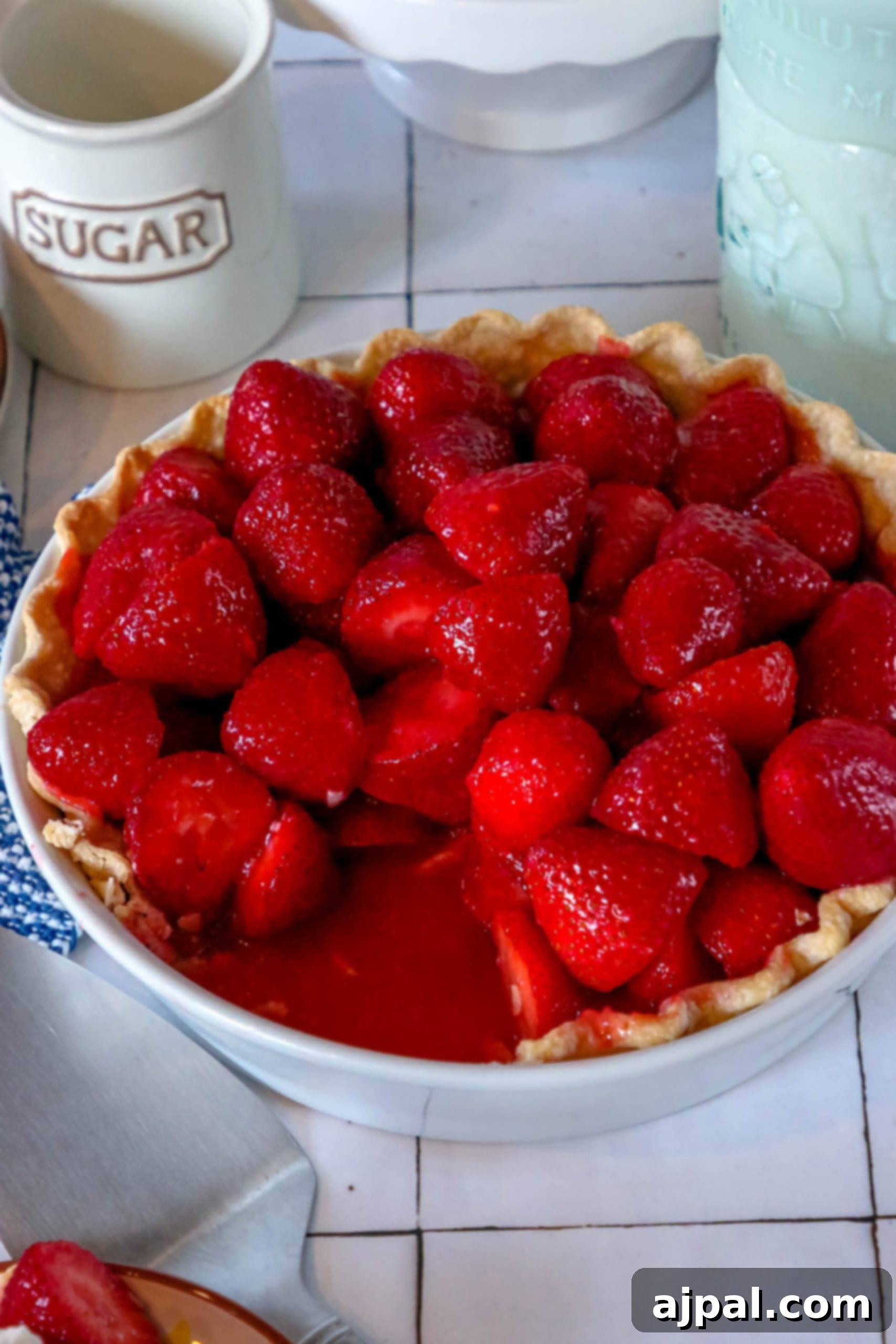 Sweet Summer Strawberry Pie 6 An easy homemade strawberry pie sits invitingly on a simple white plate, ready for a slice.