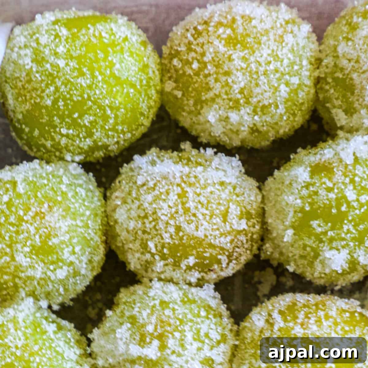 Zingy Sweet Grapes 8 Close-up of sugared green grapes covered in granulated sugar crystals, focusing on their textured surfaces.
