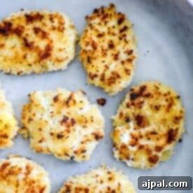 Golden brown, breaded cauliflower steaks on a gray plate.