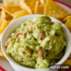 Green chili guacamole served with chips.