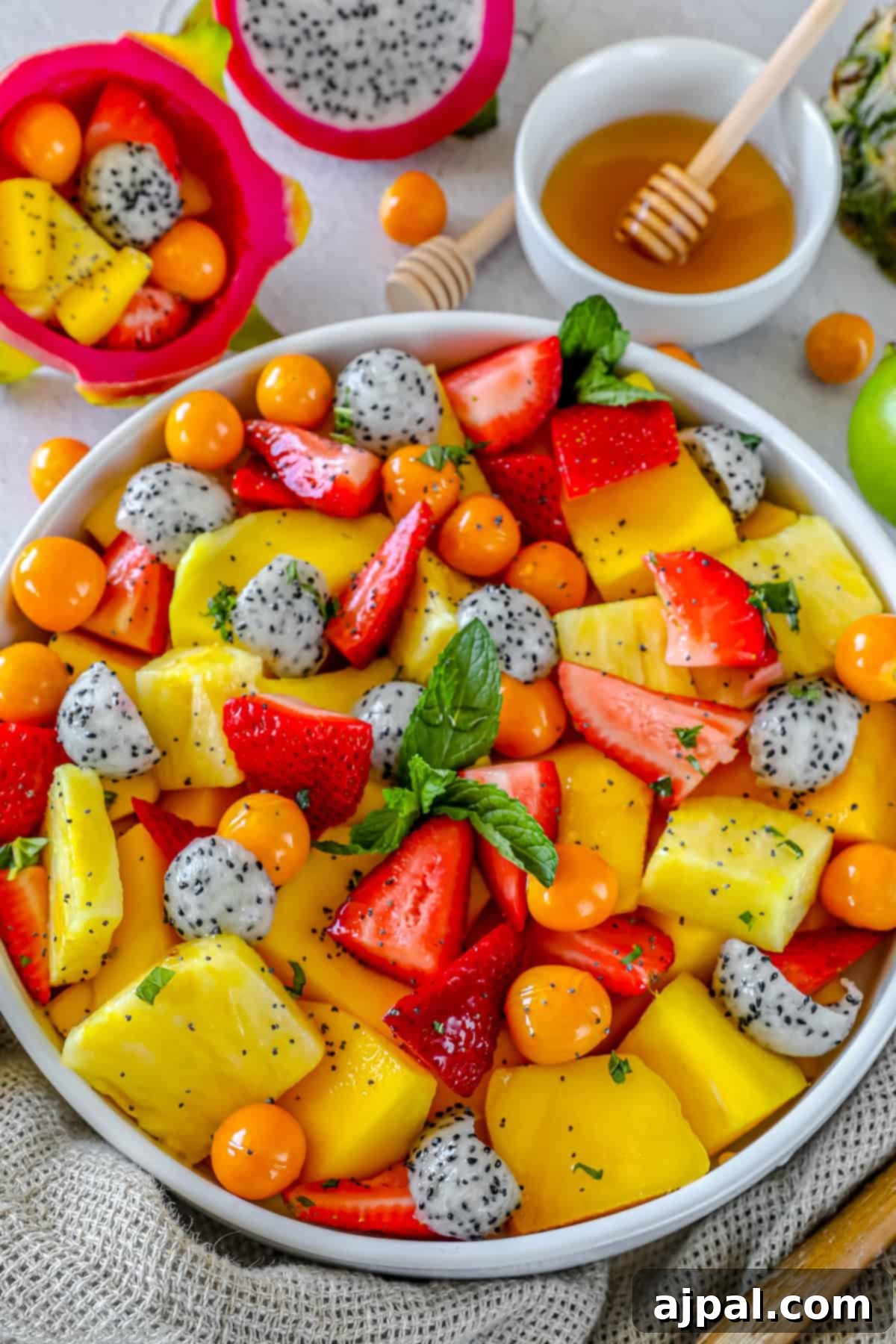 Paradise Fruit Medley 8 A closer shot of the tropical fruit salad, highlighting the details of dragon fruit, golden berries, and pineapple, with a subtle background blur.