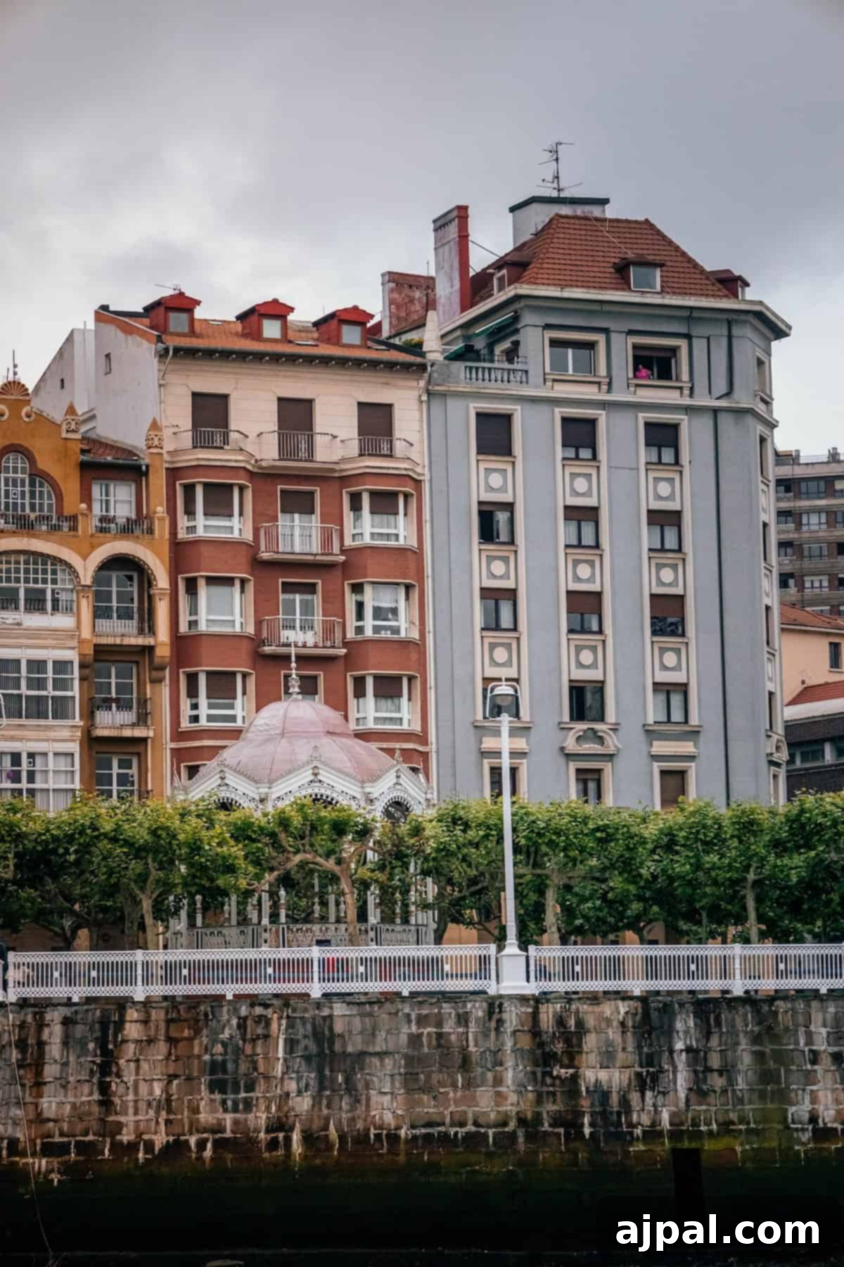 Bilbao: A Comprehensive Travel Guide 5 The iconic Guggenheim Museum Bilbao bathed in sunlight, with modern architecture reflecting in the water, a prime example of Bilbao's cultural attractions.
