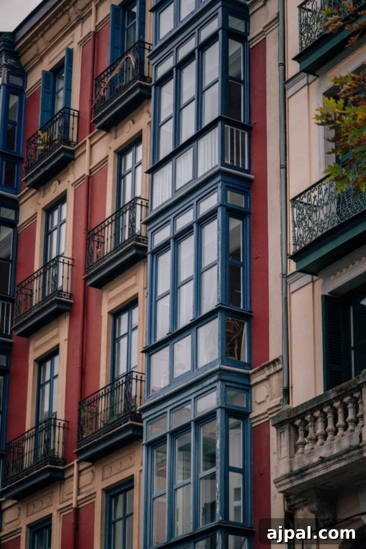 The vibrant and iconic facades of traditional buildings in Bilbao's Old Town, showcasing colorful balconies and rich architectural details.
