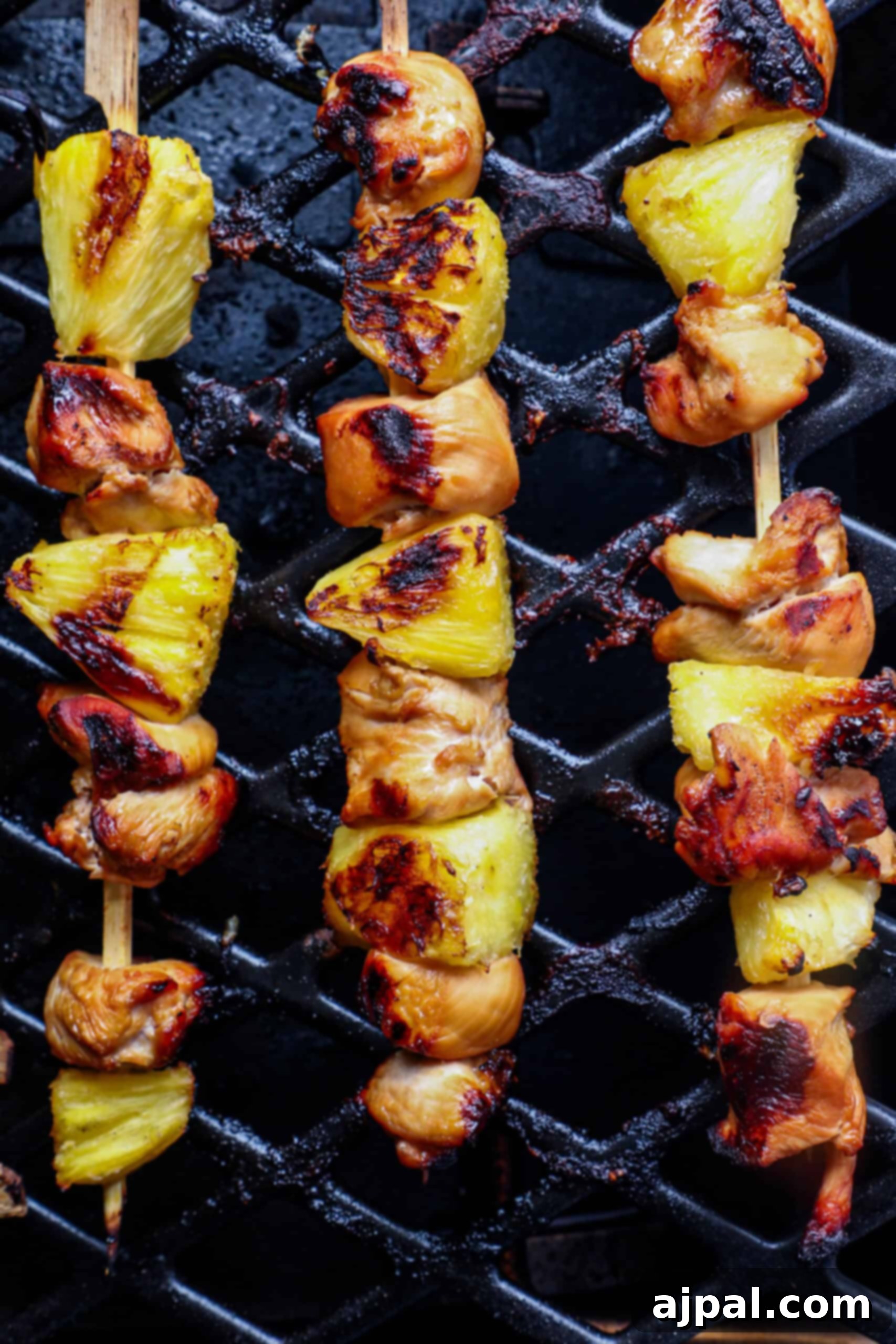 Tropical Chicken & Pineapple Skewers 3 Juicy pineapple and chicken kebabs grilling to perfection over an open flame, showcasing beautiful char marks.