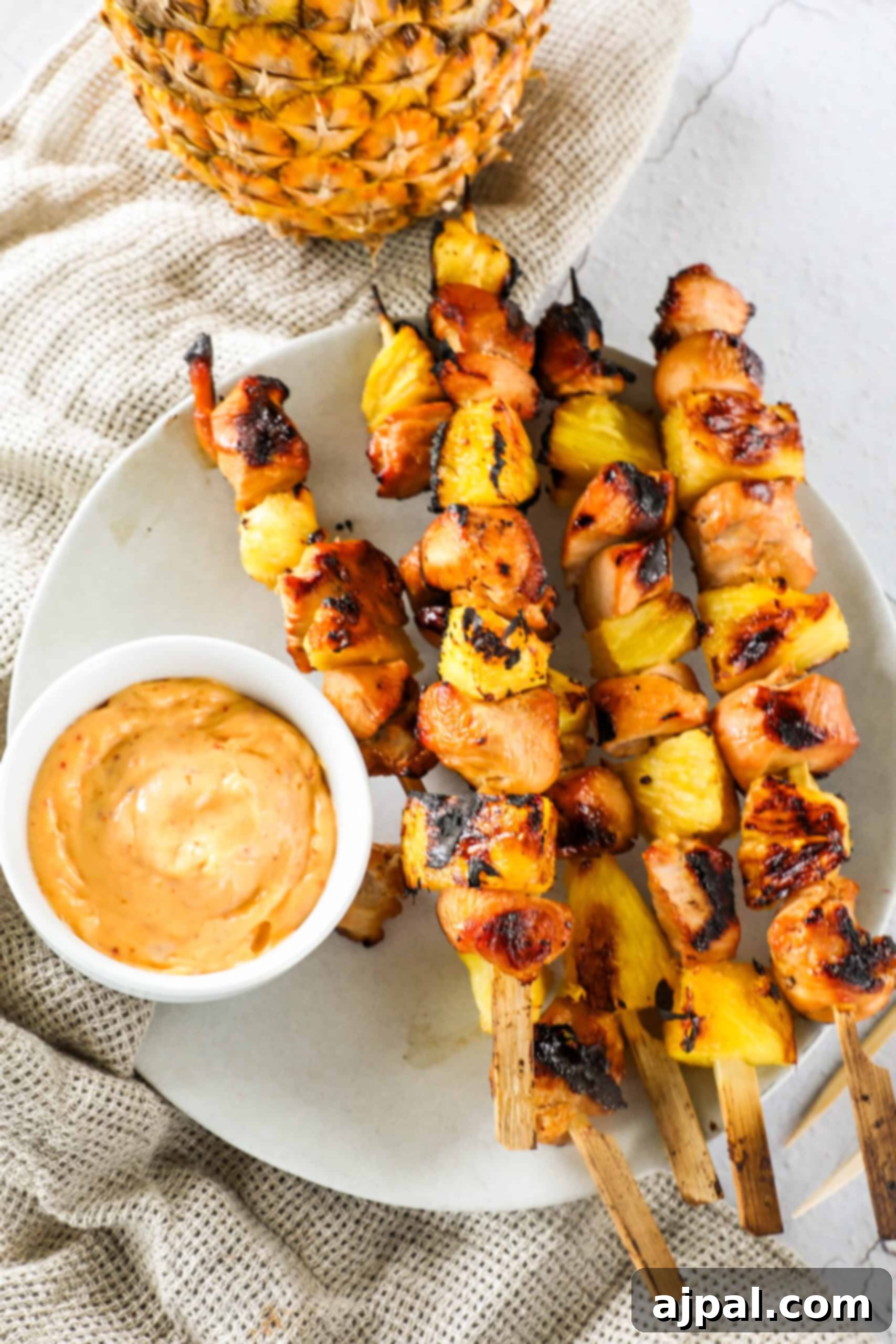 Tropical Chicken & Pineapple Skewers 6 A vibrant display of grilled pineapple and chicken kebabs, glistening with sauce and ready to be served.