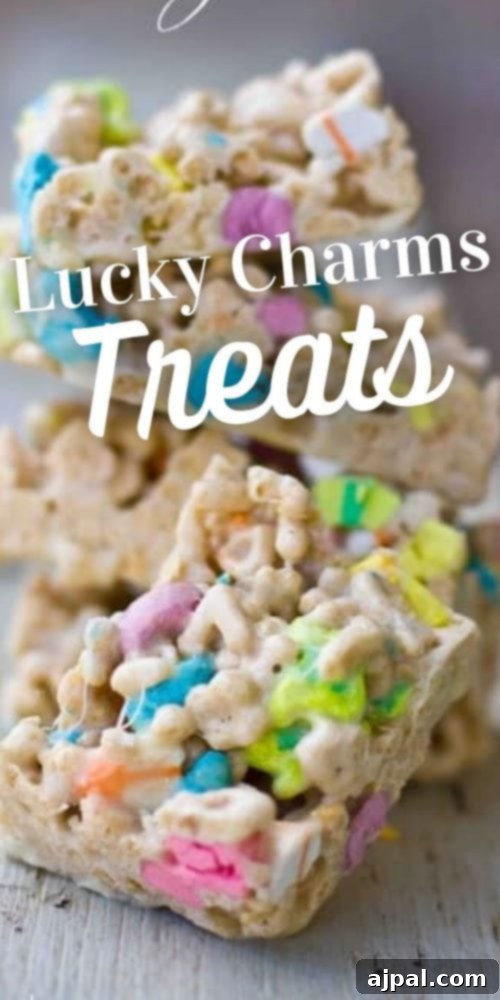 Rainbow Delights Homemade Lucky Charms Treats 4 Sliced Lucky Charms treats cereal bars on a piece of wood, ready to serve.