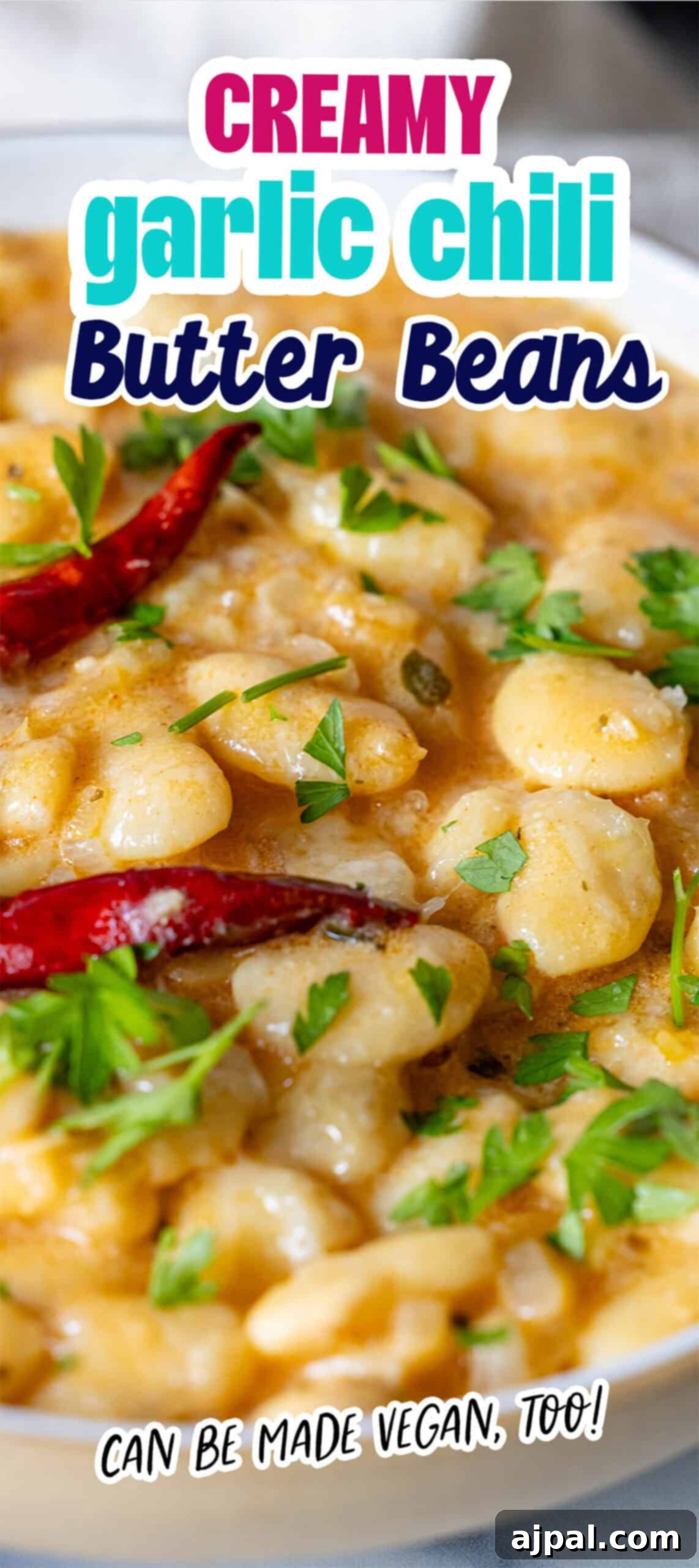 Velvety Garlic Butter Beans 10 Close-up of a dish with creamy, garlic-infused chili butter beans, garnished with herbs and whole red chilies. Labeled “Creamy Garlic Chili Butter Beans,” it can easily be made vegan too!.