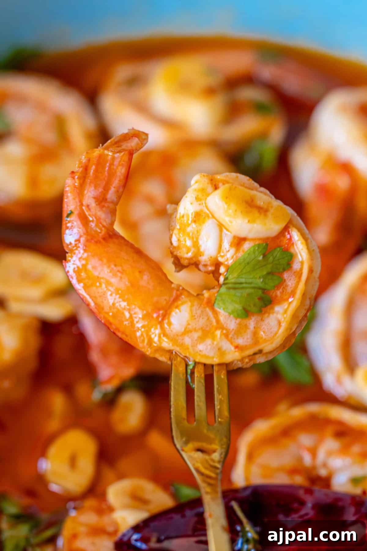 Garlic chili shrimp (shrimp pil pil) in a rustic setting, showcasing its golden oil and perfectly cooked prawns.