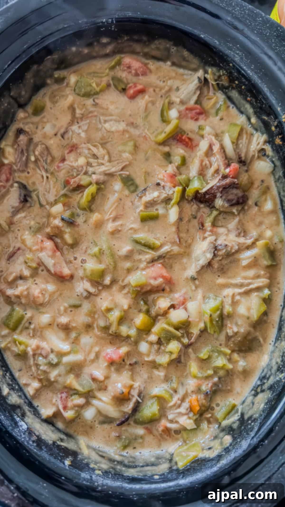A gentle stirring of all ingredients together in the slow cooker before the cooking cycle begins.