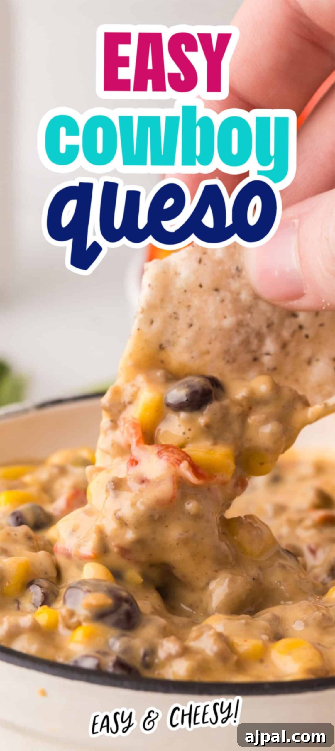 A hand dips a chip into a bowl of cheesy dip loaded with black beans, corn, and tomatoes. Labeled "Easy Cowboy Queso" with the tagline "Easy & Cheesy!" at the bottom, this queso is perfect for any gathering.