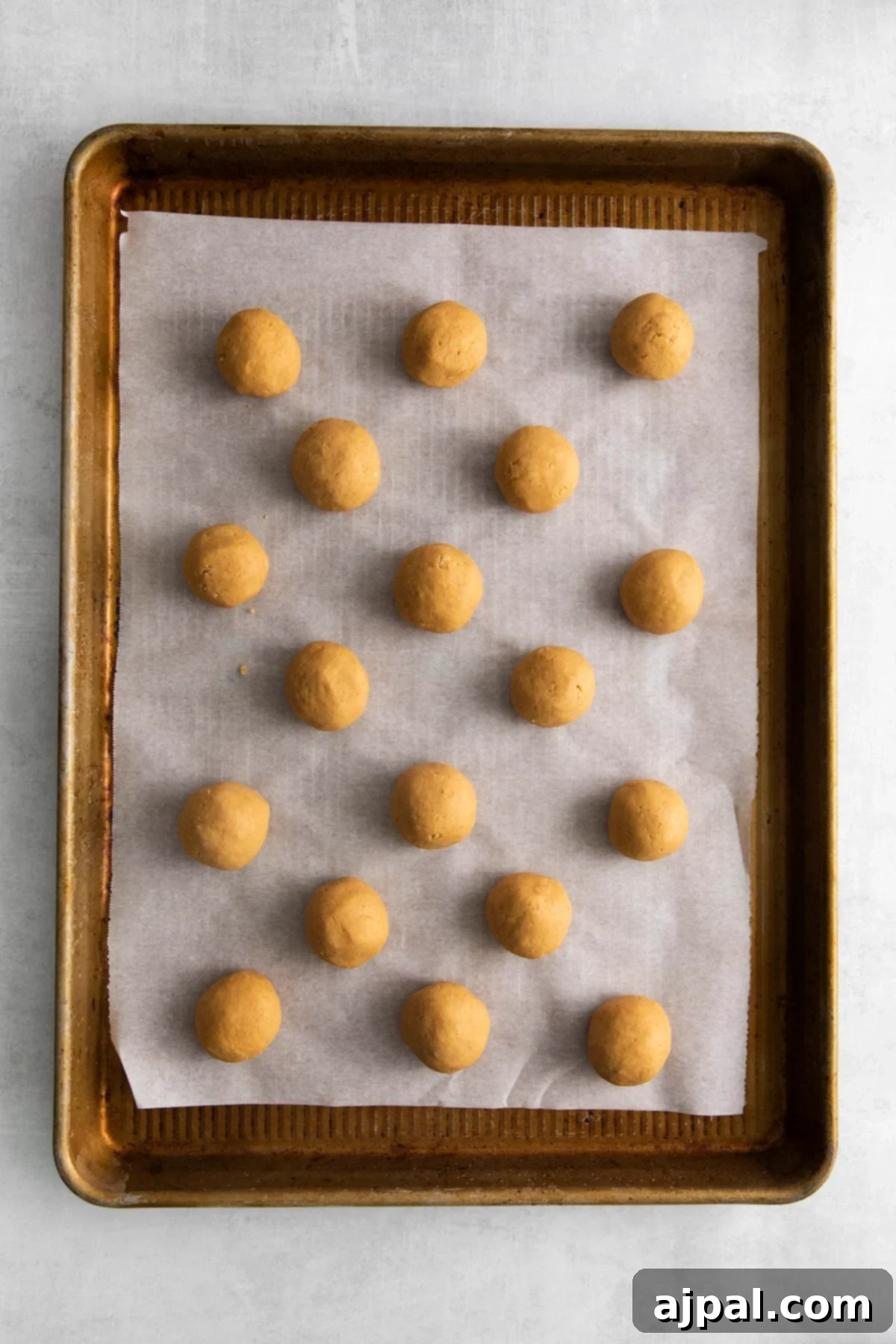picture of peanut butter truffles rolled out on a baking sheet lined with parchment paper
