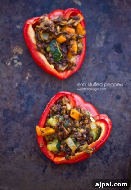 Flavor-Packed Vegan Lentil & Veggie Stuffed Peppers 3 Baked vegan lentil stuffed peppers on a baking sheet