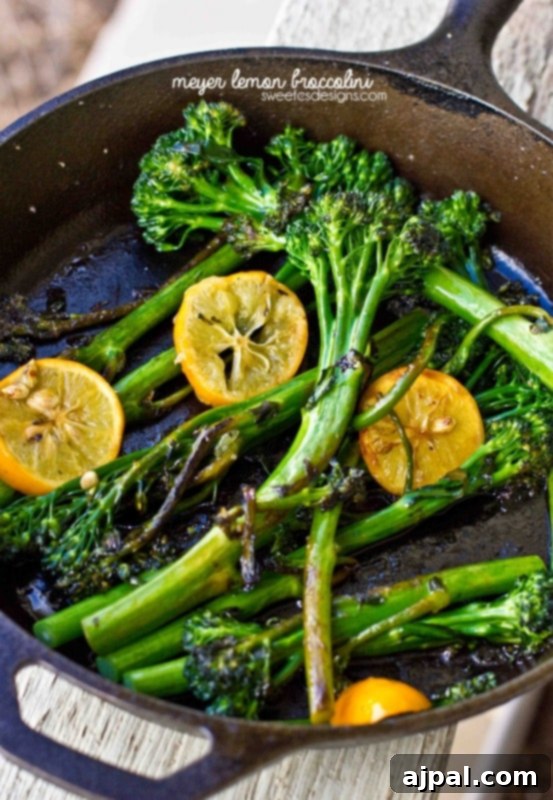 Meyer Lemon Broccolini 2 A cast iron skillet filled with bright green broccolini and thinly sliced Meyer lemons, ready to be served as a delicious side dish.