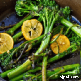 Meyer Lemon slices and Broccolini are being sautéed in a pan.