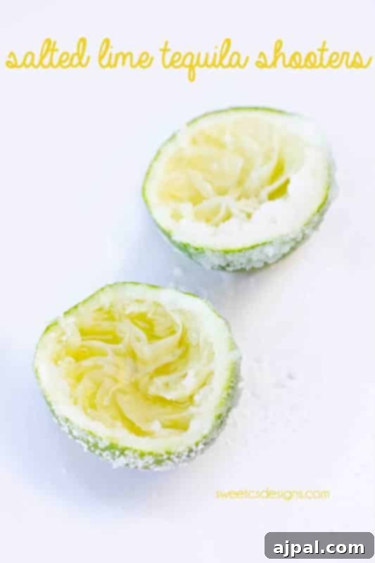 Tequila's Zesty Salted Kiss 3 A freshly juiced lime half, perfectly salted and brimming with tequila, positioned on a crisp white background, ready to be enjoyed.