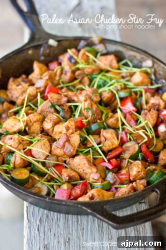 Flavorful Paleo Asian Chicken Stir Fry with tender chicken, colorful vegetables, and pea shoots, easy to make and delicious.