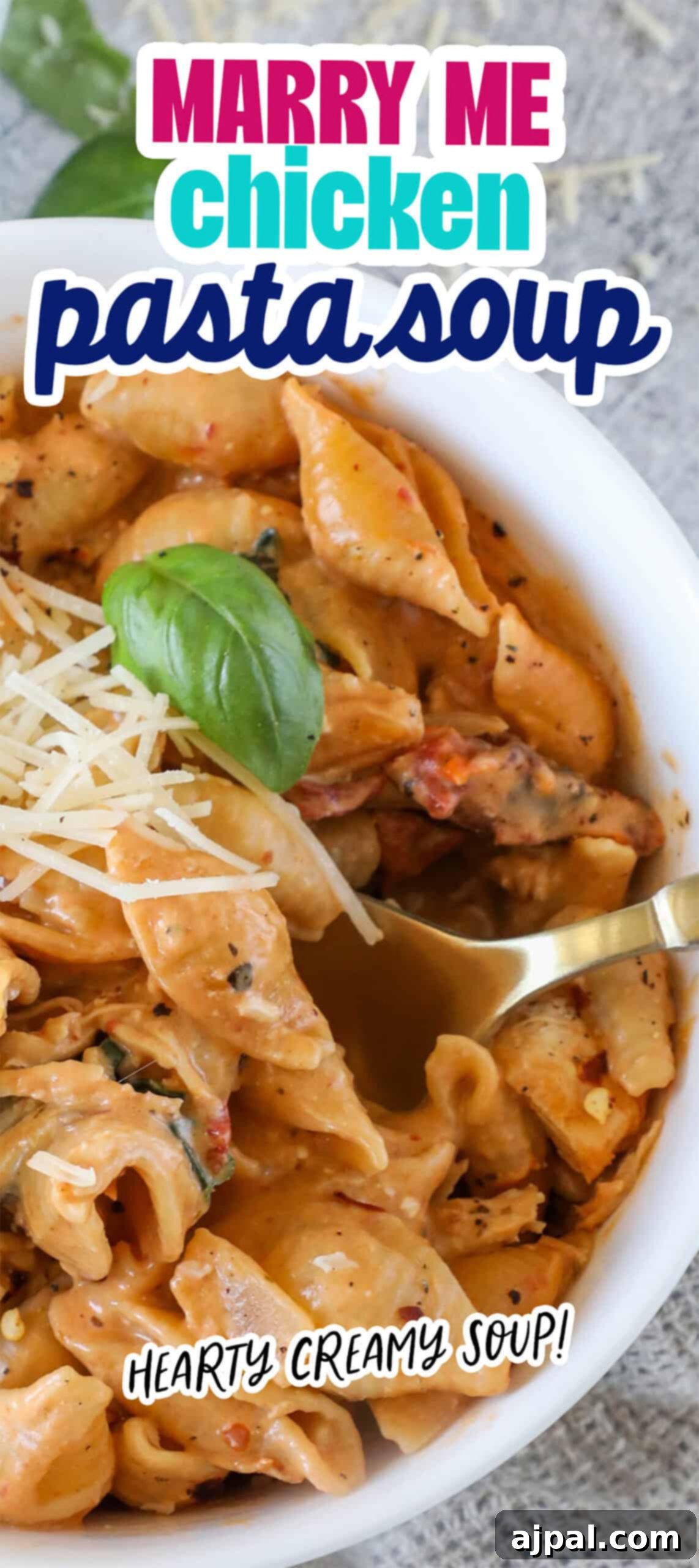 A vibrant bowl of Marry Me Chicken Pasta Soup, featuring tender chicken, pasta, fresh basil, and grated cheese, with text overlays reading 'MARRY ME chicken pasta soup' and 'HEARTY CREAMY SOUP!'.
