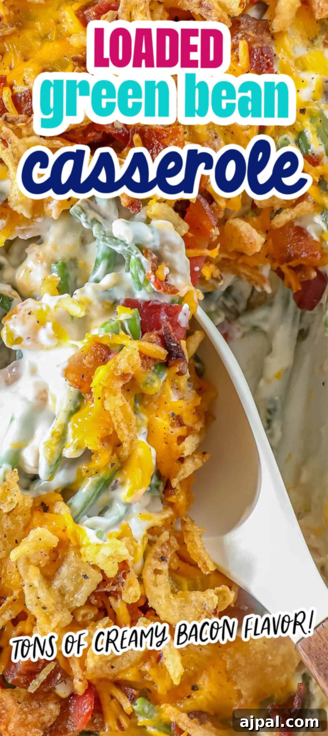 Ultimate Green Bean Bake 10 A close-up of a delectable green bean casserole reveals creamy sauce, bacon, cheese, and crispy fried onions as a spoon scoops from the dish.