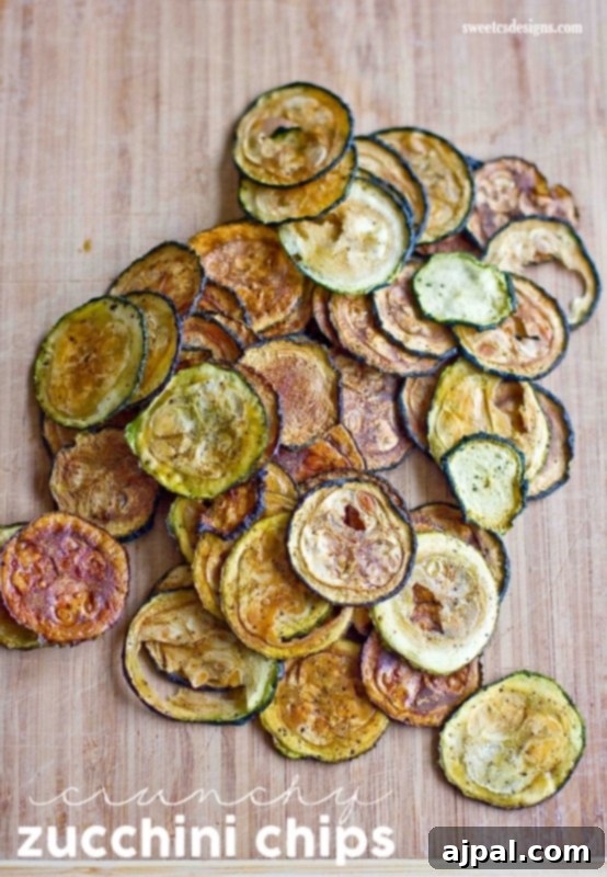 Golden Baked Zucchini Crisps 2 Crispy baked zucchini slices seasoned with salt and pepper, ready to be enjoyed as a healthy snack.