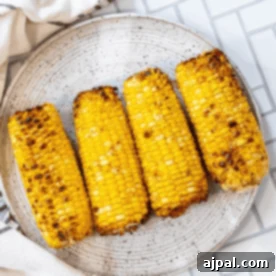 The best grilled corn on the cob recipe, beautifully presented on a plate.