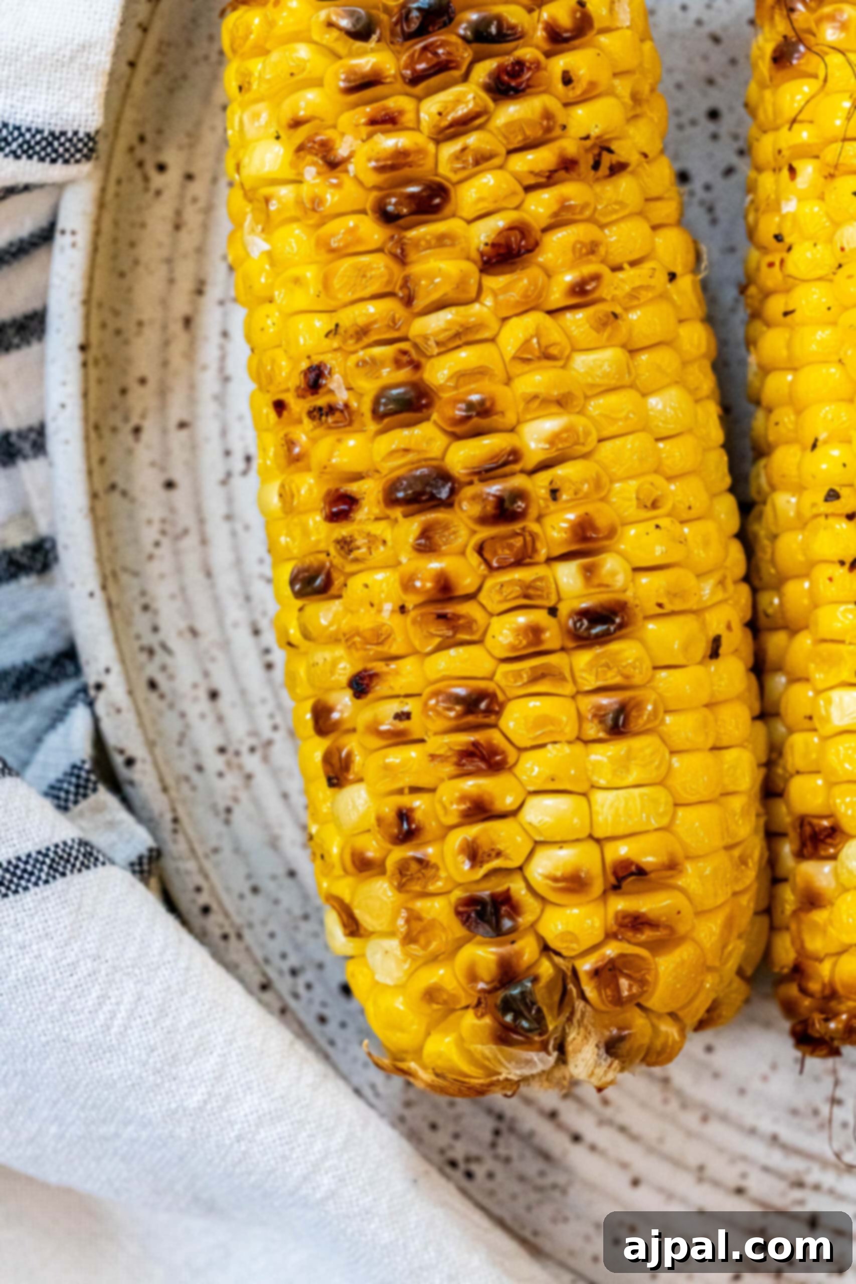 picture of charred corn on the cob on a plate