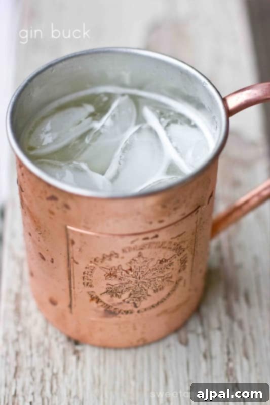 A refreshing Gin Buck cocktail, a delicious twist on the Moscow Mule, served in a copper mug with a lime garnish.