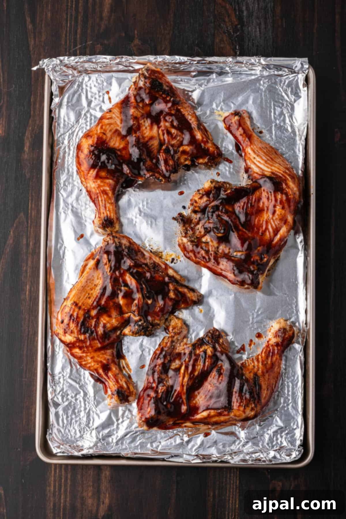 Juicy BBQ Chicken Quarters 2 Grilled barbecue chicken quarters with a rich, dark glaze and fresh herbs.