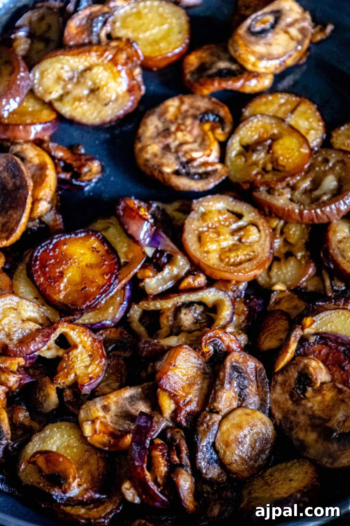 Mediterranean Vegan Sabich Bowls 9 fried eggplant and mushrooms in a pan