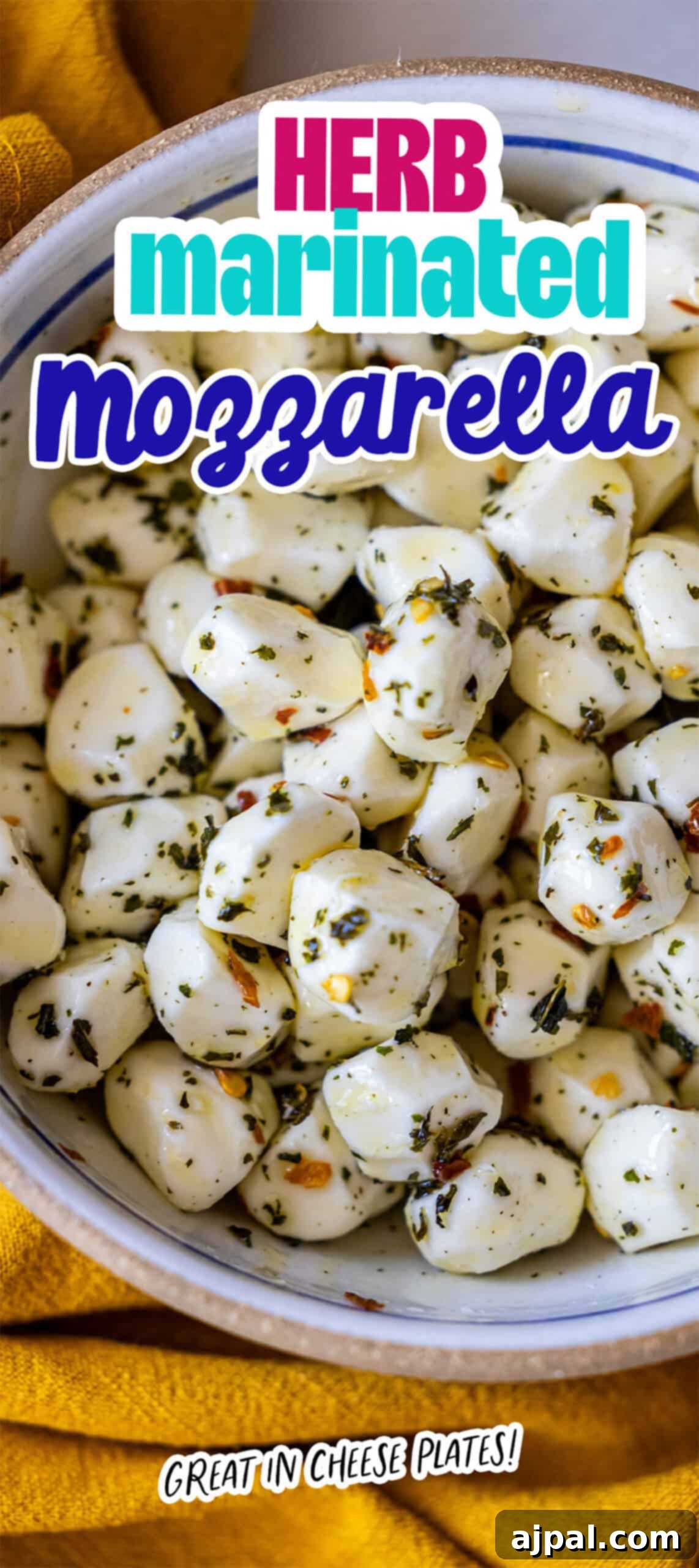 A bowl of vibrant herb-marinated mozzarella balls, beautifully seasoned with a medley of herbs and spices, elegantly placed on a sunny yellow cloth. The accompanying text reads: 'Herb marinated mozzarella balls. Great in cheese plates!' – highlighting its versatility and appeal as a perfect appetizer for any gathering.