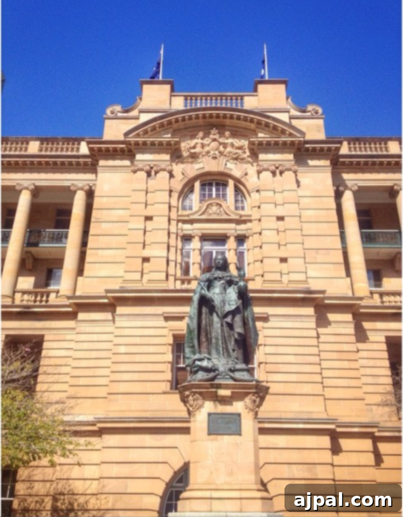 Experience Brisbane Australia 8 The grand Treasury Hotel, an ornate historic building in Brisbane, Australia, with a striking statue at its entrance. A significant landmark for city tours.