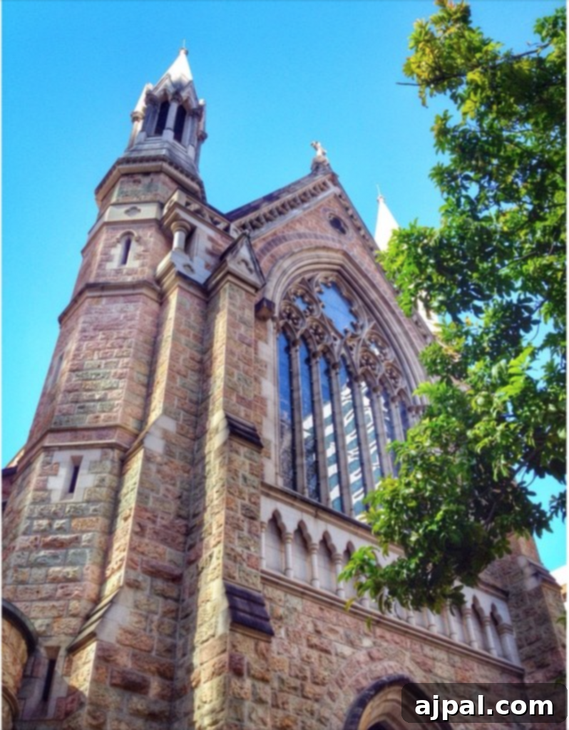 Experience Brisbane Australia 9 Beautiful exterior of St Stephen's Cathedral in Brisbane, Australia, featuring its steeple and spire against a sunny sky. A notable landmark for tourists.