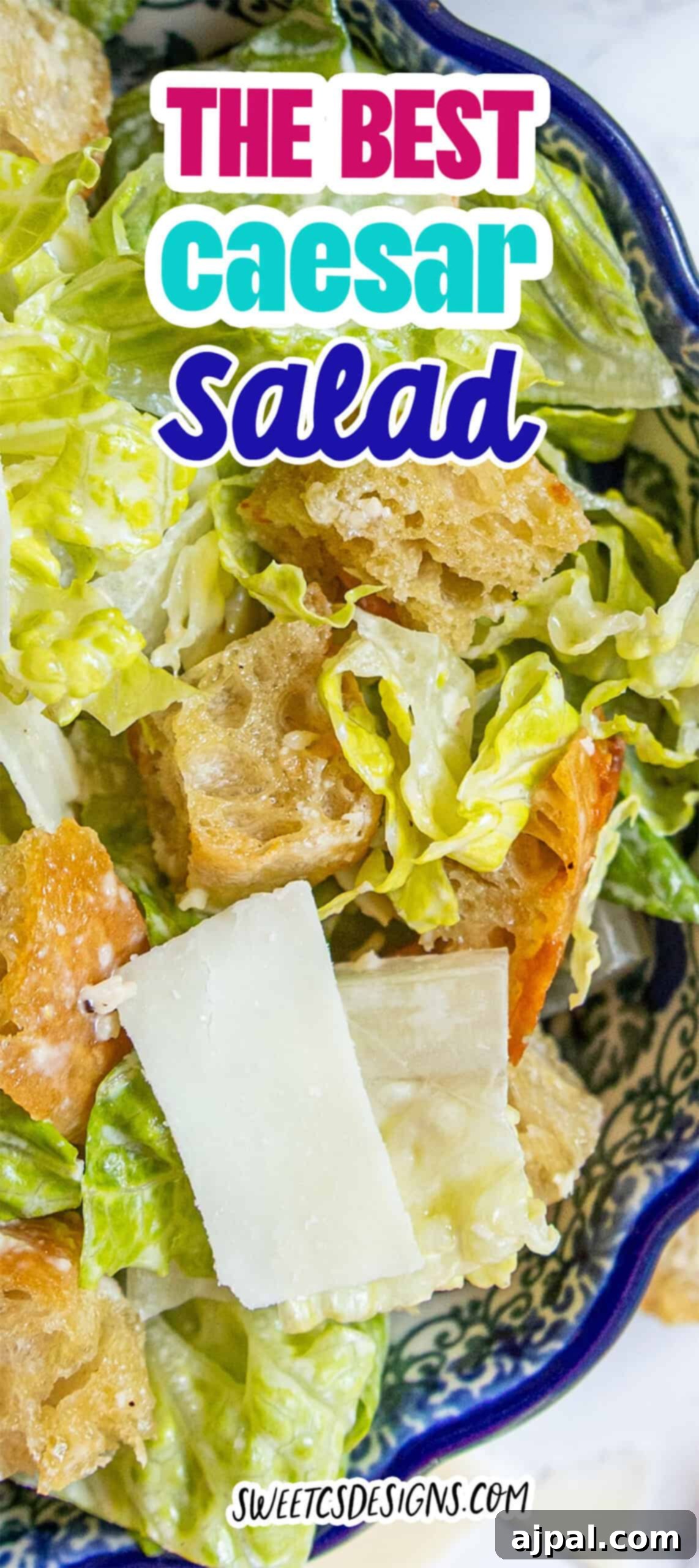 The Ultimate Caesar Salad 9 A mouth-watering bowl of Caesar salad, abundant with crisp romaine lettuce, golden-brown croutons, and delicate shaved Parmesan cheese, all generously coated in a rich, creamy Caesar dressing. A text overlay proudly declares "The Best Caesar Salad" with the website "sweetsdesigns.com" subtly included.