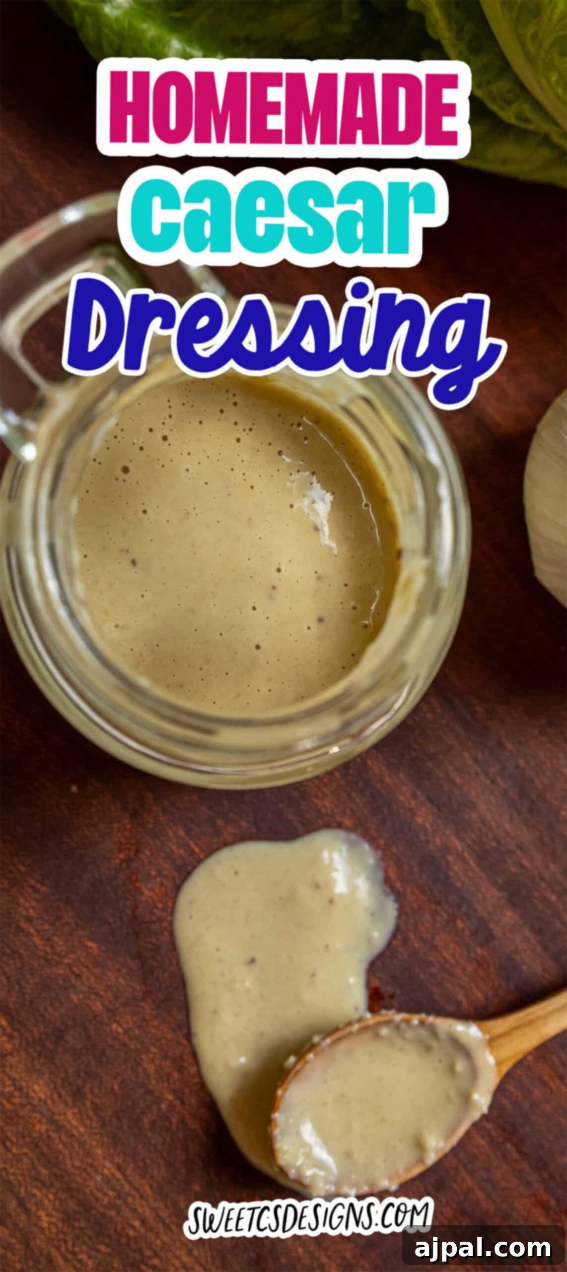 Glass jar and wooden spoon with creamy caesar dressing on a wooden surface, a bit spilling from the spoon; text reads "Homemade Caesar Dressing.