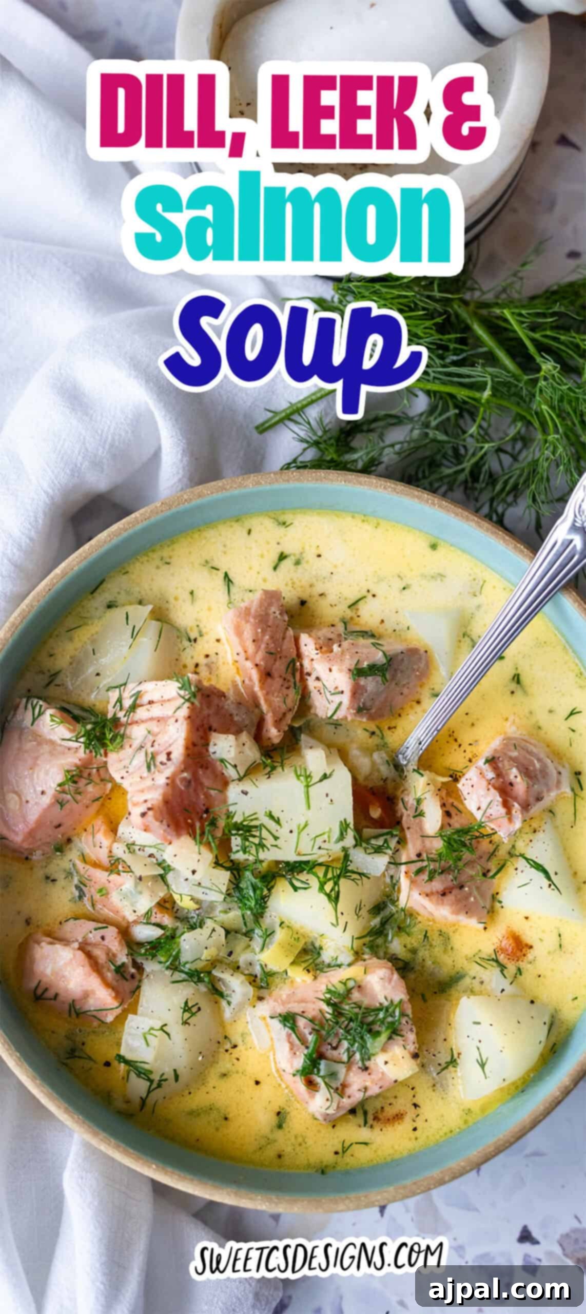 Traditional Finnish Salmon Soup 14 A bowl of creamy dill, leek, and salmon soup with potato chunks, garnished with fresh dill, sits next to a sprig of dill and a spoon—classic Finnish Salmon Soup (lohikeitto) at its best.