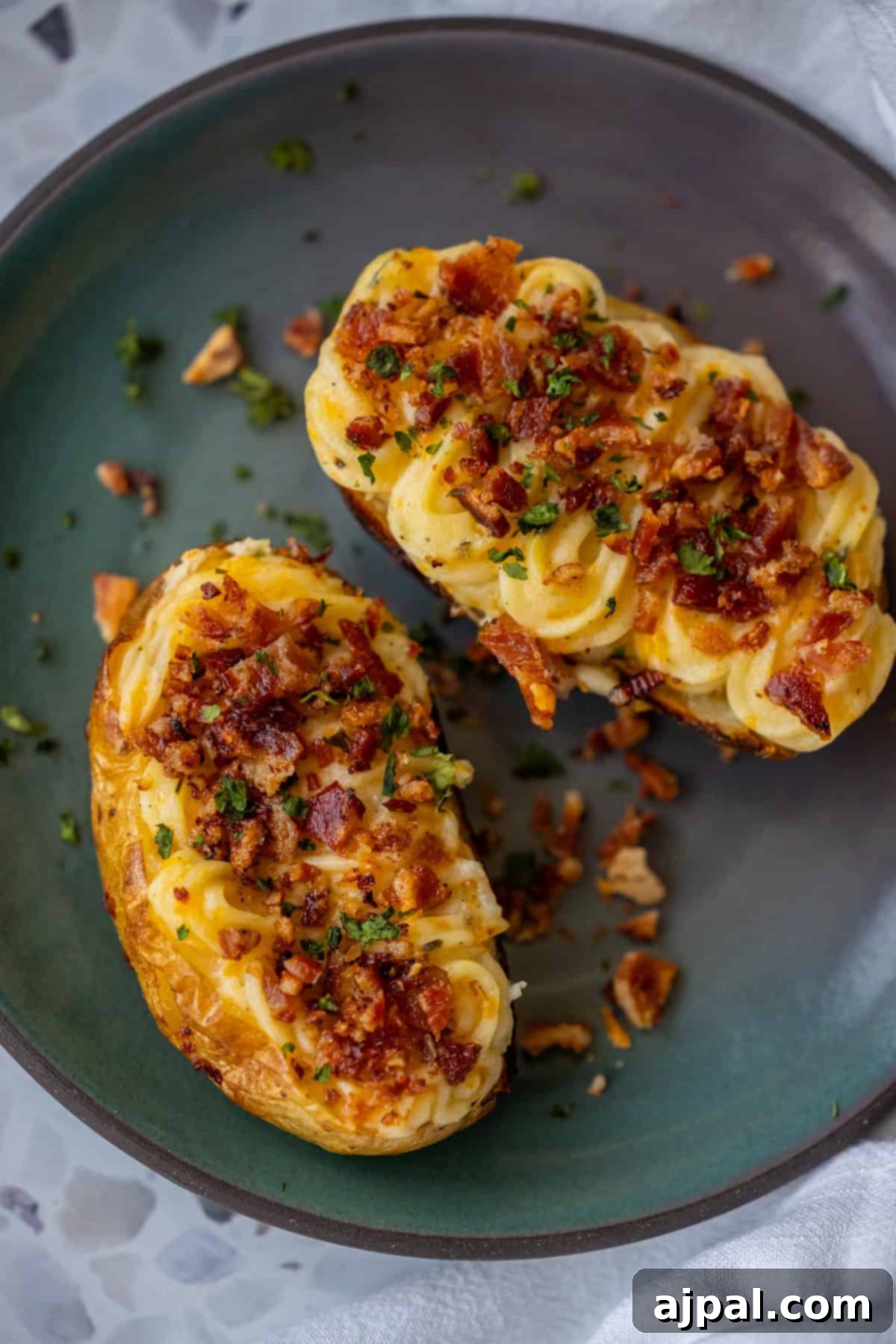 The Ultimate Double-Baked Potato 10 Two richly loaded twice-baked potatoes, perfectly golden and garnished with fresh herbs, ready to be enjoyed as a hearty side or main dish.