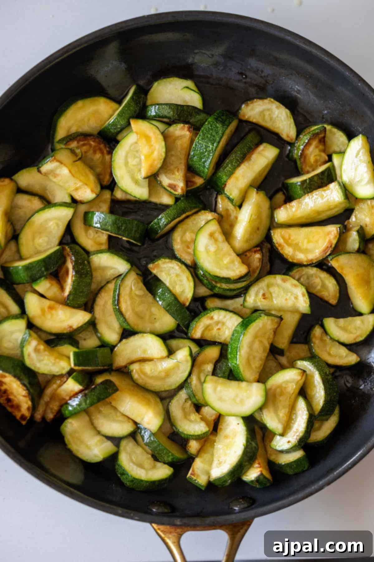 Marry Me Zucchini and Bean Delight 8 Sliced zucchini and beans being sautéed in a black skillet for a simple, delicious side dish.