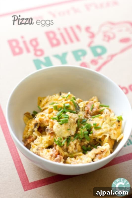 A vibrant bowl of pizza eggs, featuring fluffy scrambled eggs mixed with pieces of leftover pizza, generously topped with fresh chives, ready for a delicious breakfast.