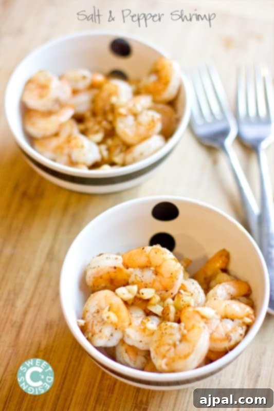 shrimp with salt and pepper and garlic in a bowl on a wooden cutting board