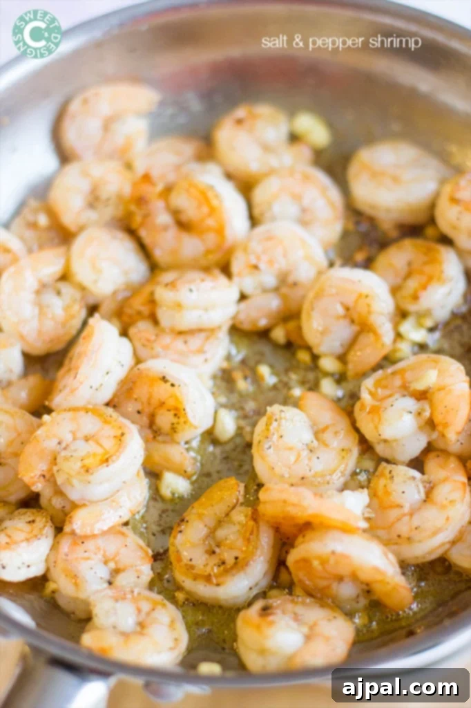 shrimp in a pan with garlic, salt, and pepper