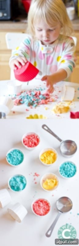 Homemade Gluten-Free Moon Sand 4 A little girl playing happily with colorful gluten-free moon sand and spoons in a sensory bin.