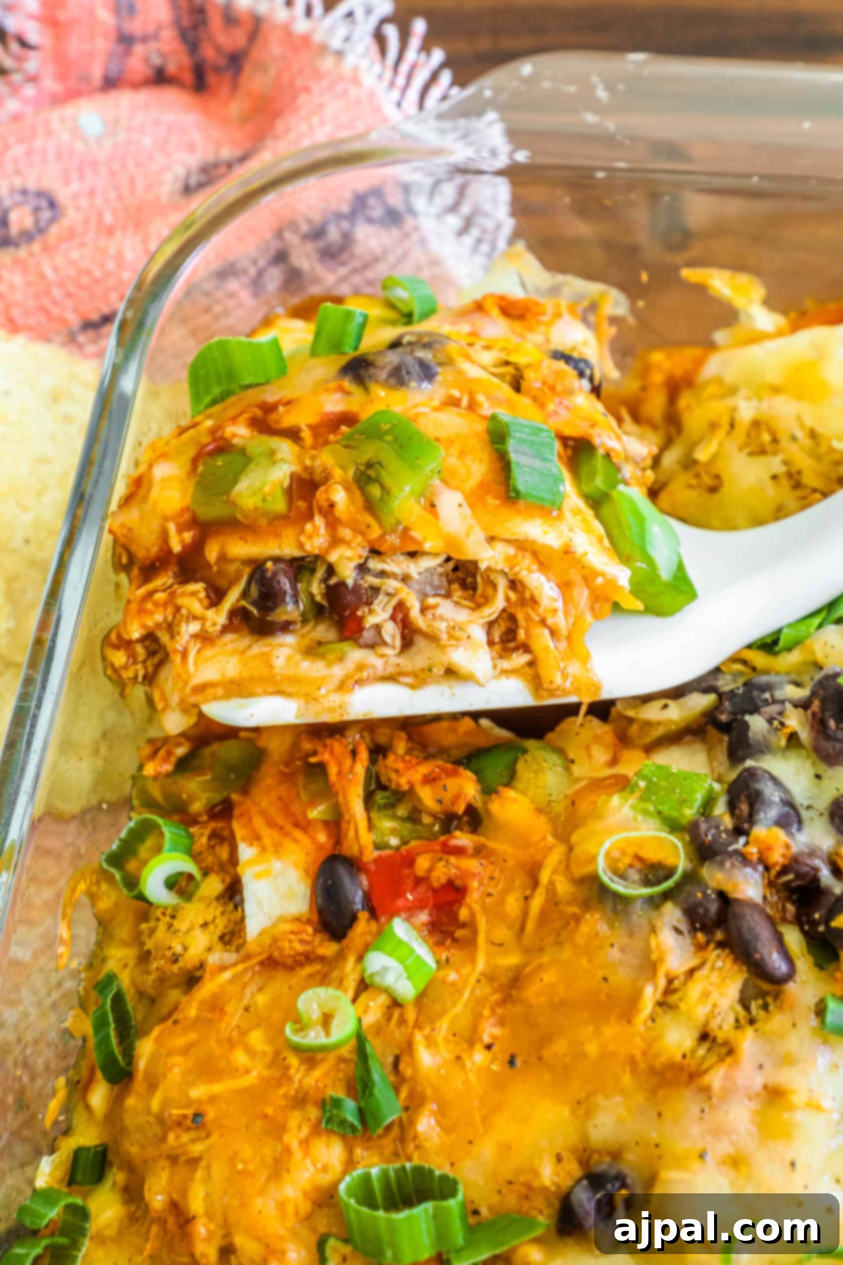 Simple Savory Chicken Bakes 11 A vibrant Chicken Taco Casserole, bursting with Mexican-inspired flavors, topped with melted cheese, fresh cilantro, and a dollop of sour cream, ready to be served.